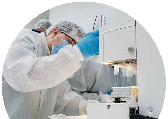 Man in lab coat looking at multiplex machine